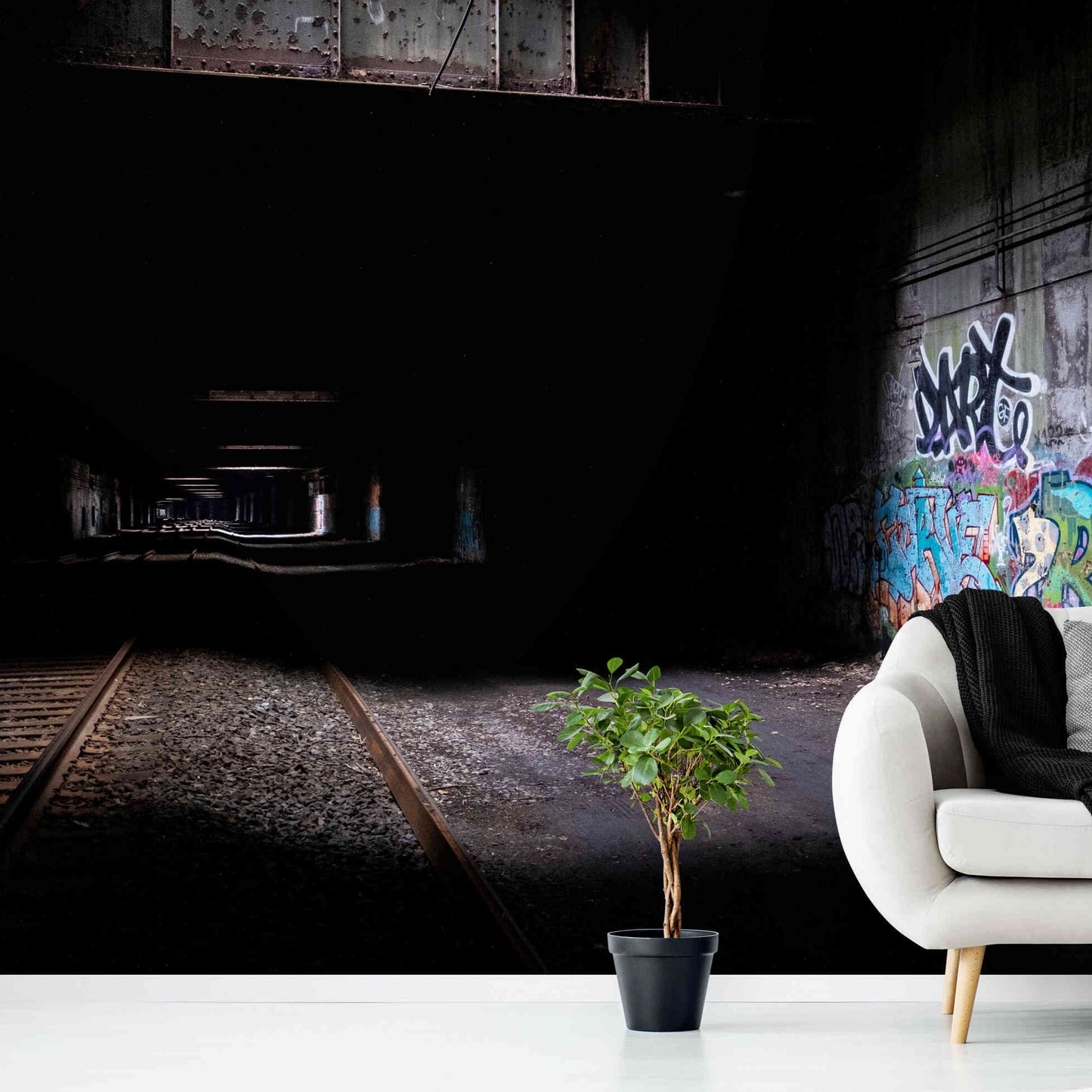 Expressive graffiti bridges light and dark in captivating tunnel wall art.