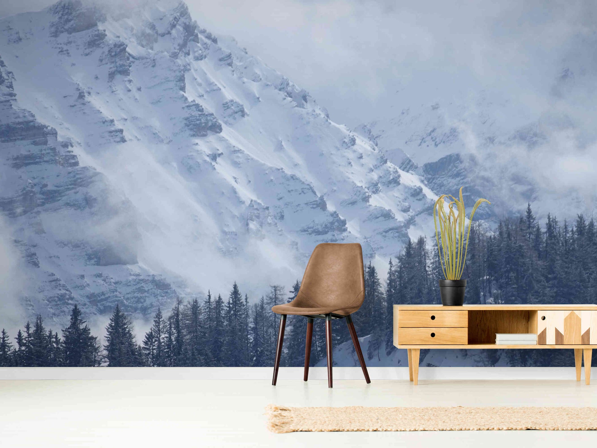 Snowy mountains wall mural displayed in a modern living room, highlighting its serene and elegant winter design