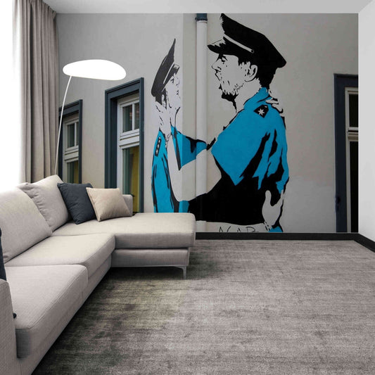 A poignant expression of love and authority in the Banksy Police Kiss graffiti mural, bringing edgy art into home decor.