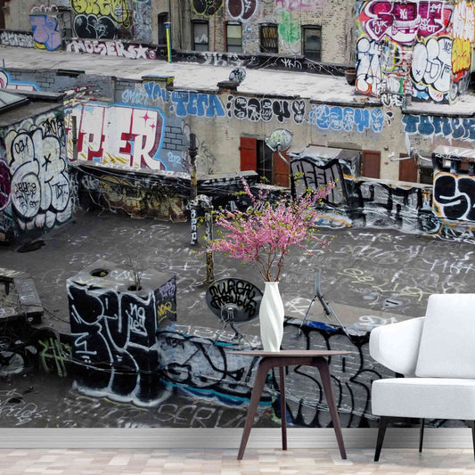 Dynamic graffiti art on an urban rooftop captured in wall mural wallpaper.